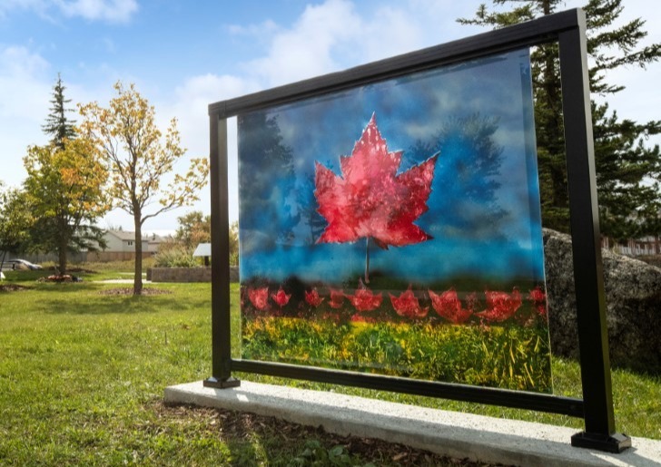 An art installation that has a red maple on a blue background.  