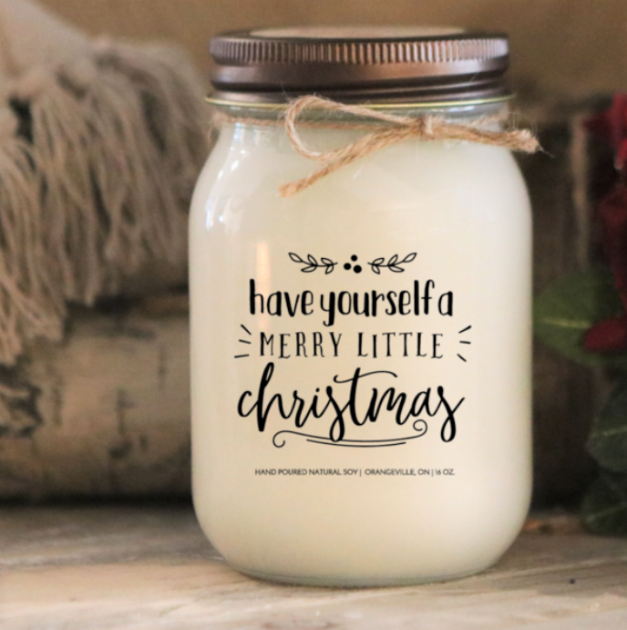 A mason jar candle with text "have yourself a merry little Christmas" 