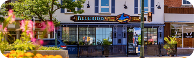 A storefront with a sign that reads Bluebird Cafe and Grill