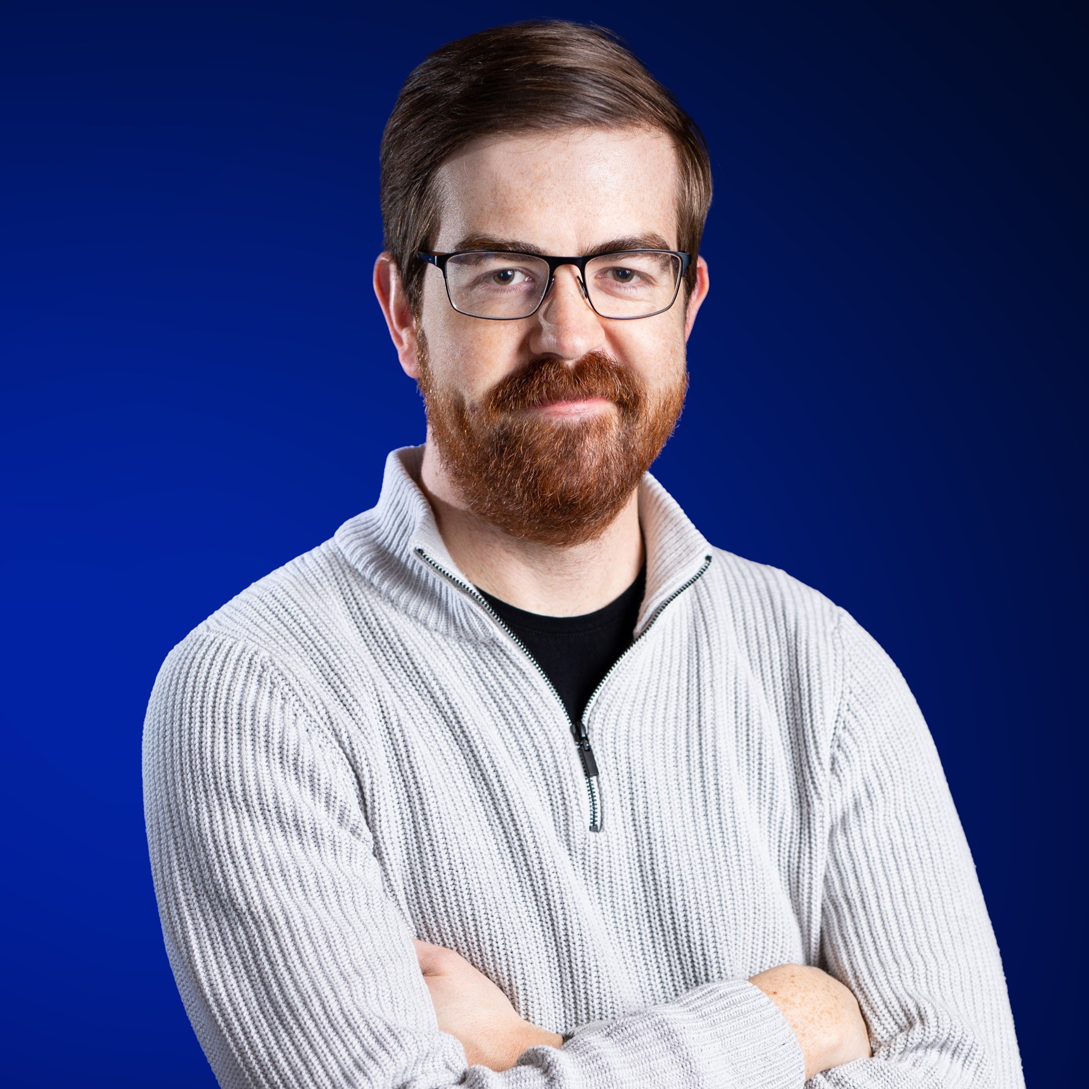 Man with glasses on blue background