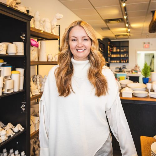 A person standing in a pottery studio