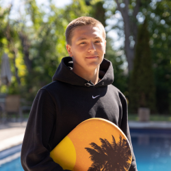Young man standing in front of pool
