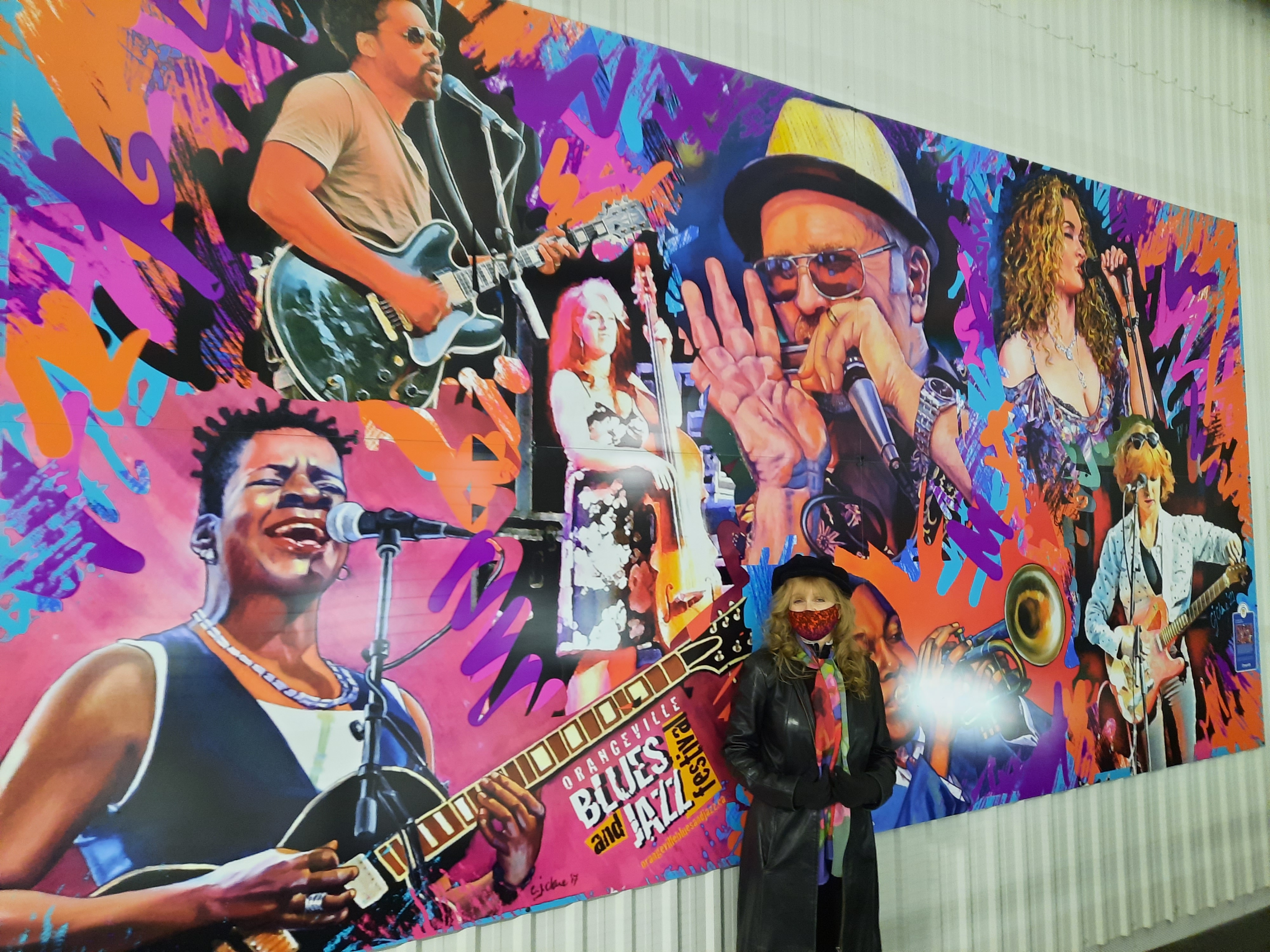 Christina Clare with her painting of multiple music artists