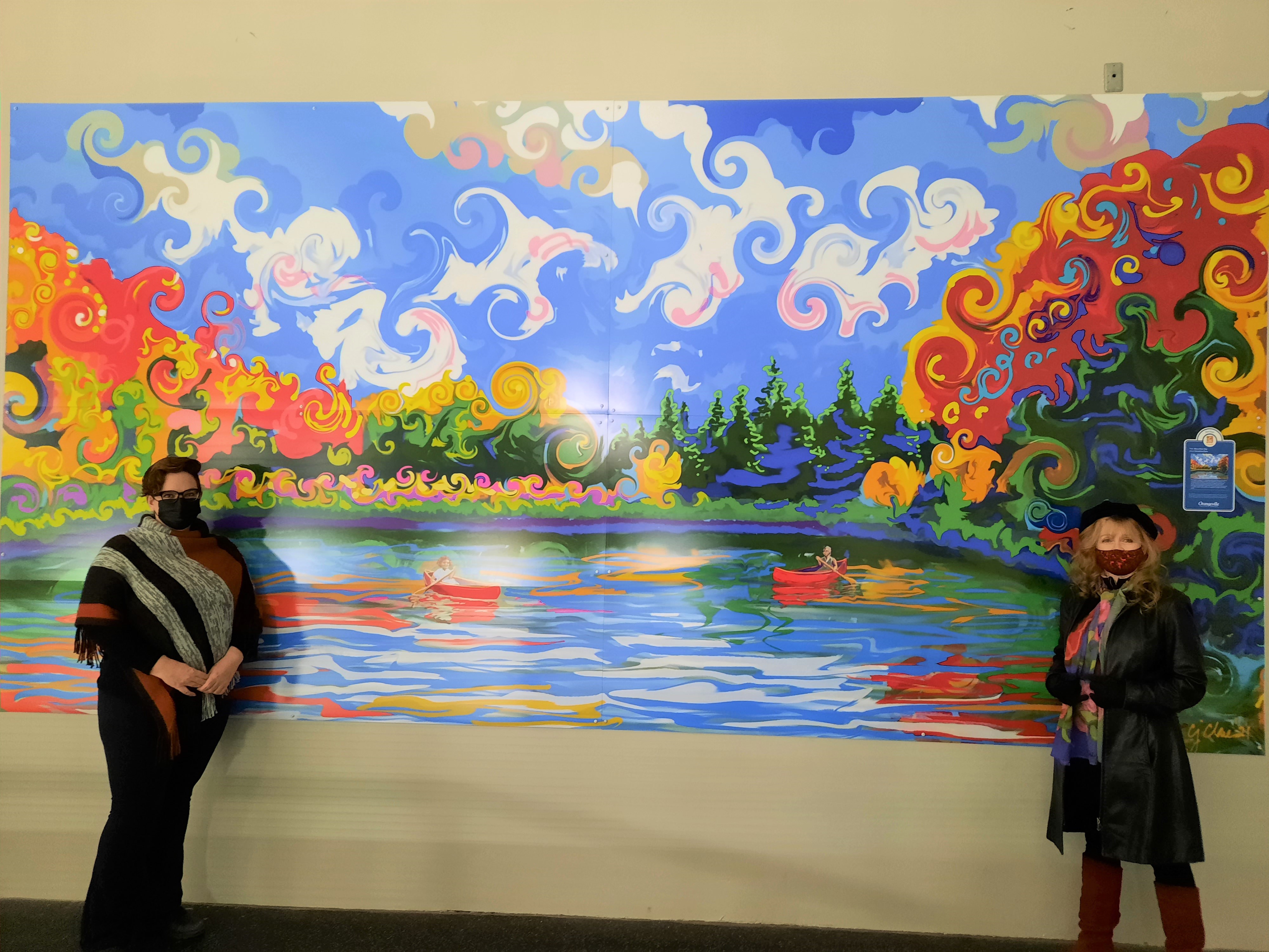 Christina Clare and Councillor Lisa Post standing next to a landscape painting