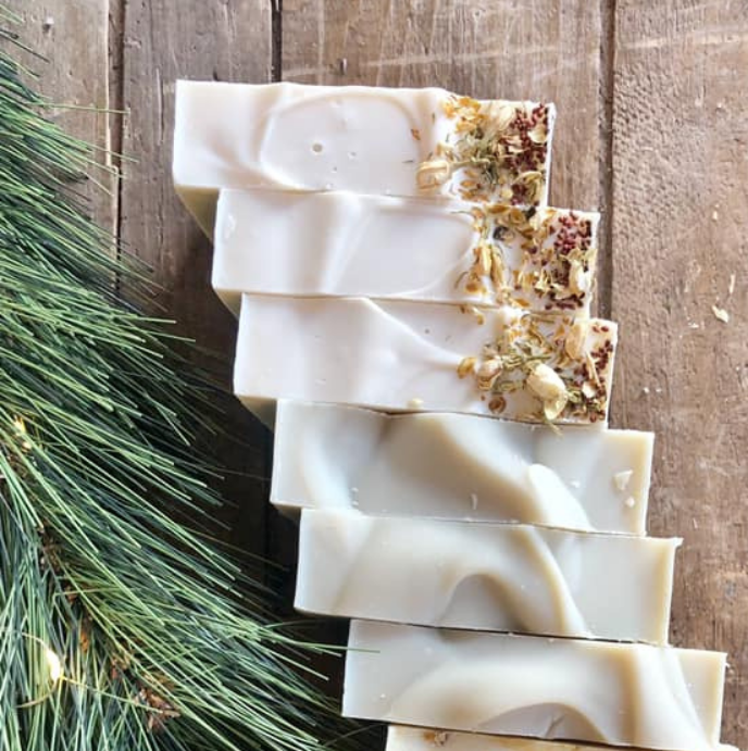 A row of handmade soaps on a wooden table