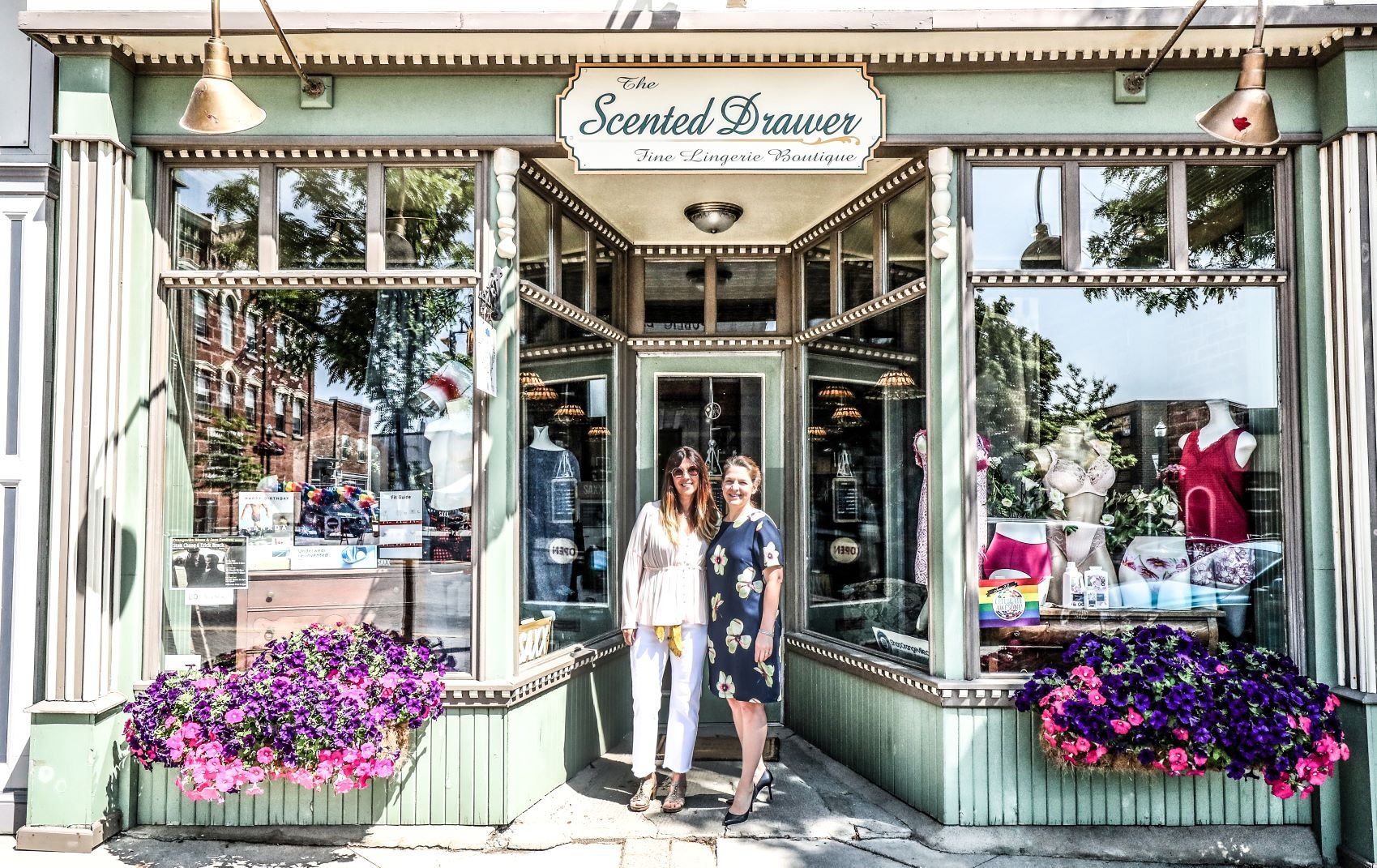 Two women standing in front of a retail shop