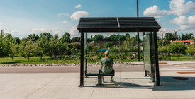 A person sitting in a bus shelter