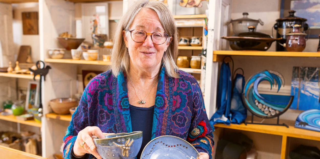 Woman holding pottery at an art studio