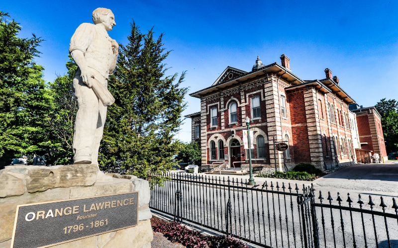 Statue of a man beside a Town Hall building in Orangeville